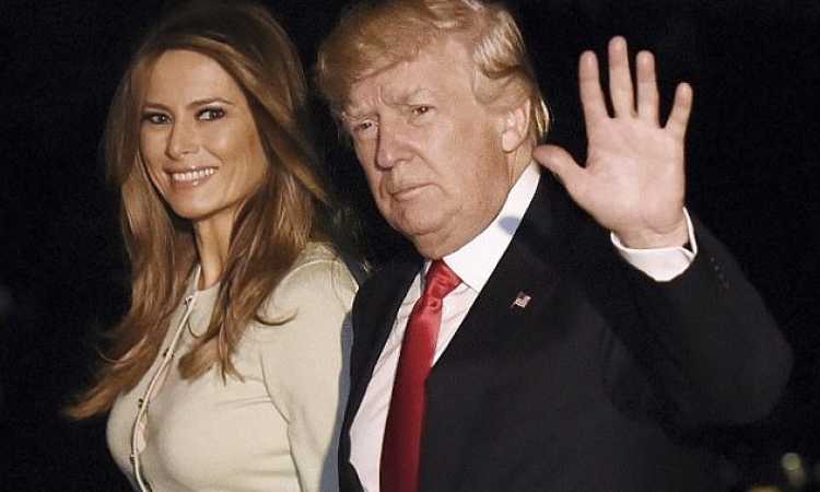 ترامب يعود أمريكا ممسكا بيد ميلانيا