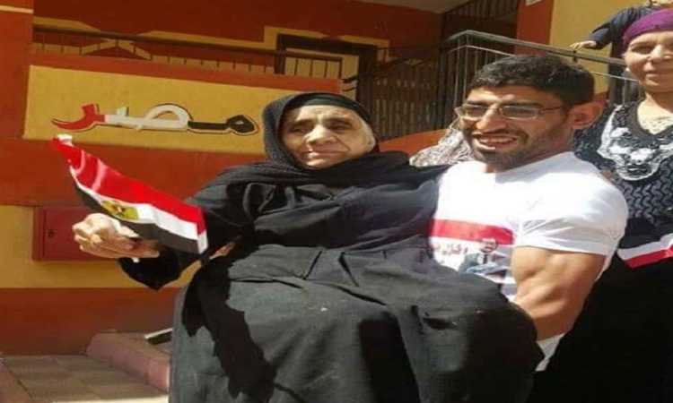 شاب يحمل أمه إلى لجنتها الانتخابية